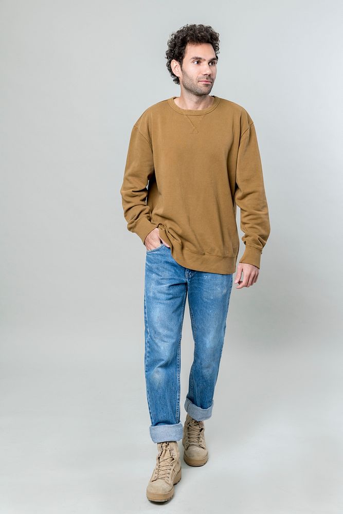 Man in brown sweater and blue jeans