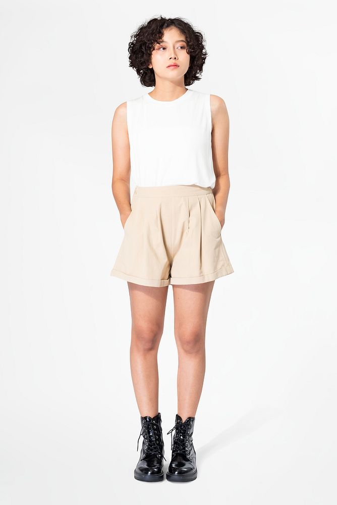 Woman in white tank top and beige shorts with design space summer apparel