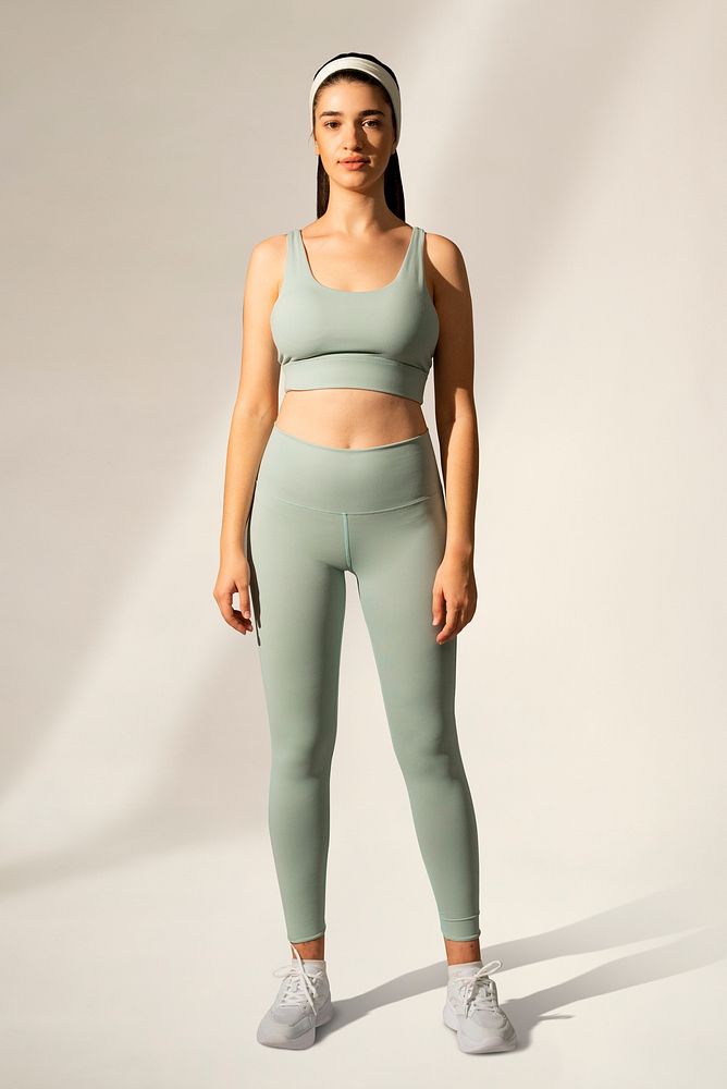 Woman in green sports bra and yoga pants activewear apparel full body
