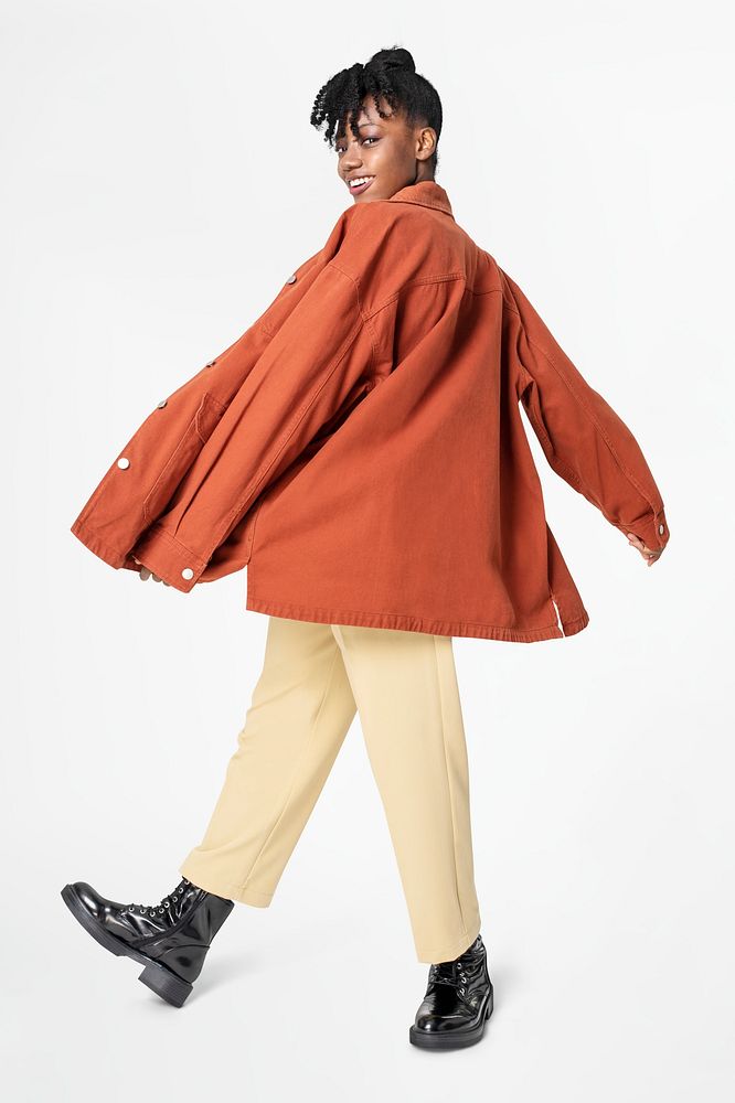 Woman in orange oversized jacket street style apparel rear view