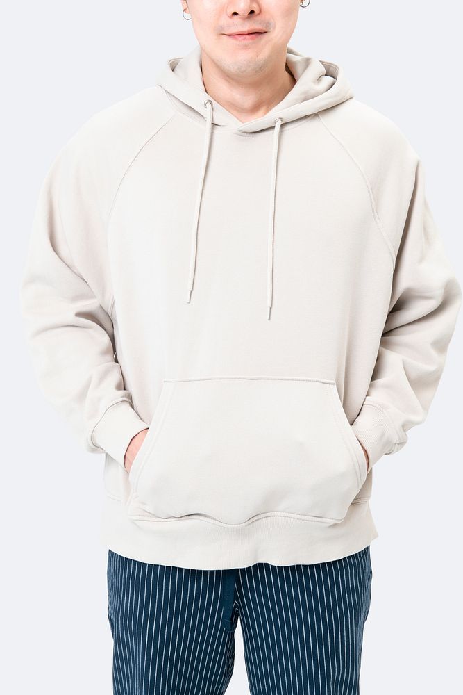 Handsome man wearing white hoodie for winter fashion studio shoot