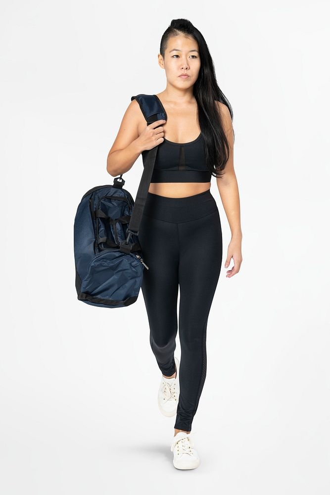 Healthy woman mockup psd in black sportswear carrying gym bag full body