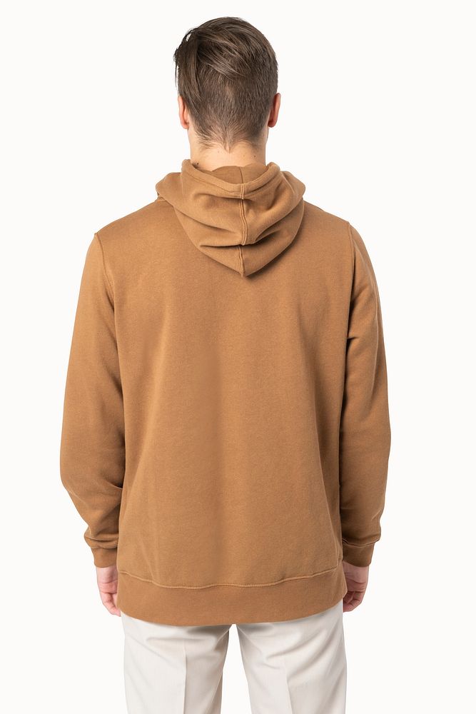 Handsome man wearing brown hoodie for winter fashion studio shoot rear view