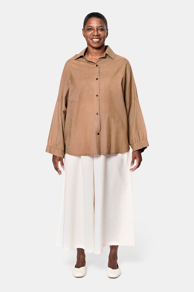 African American woman wearing brown long-sleeve shirt with white culotte pants