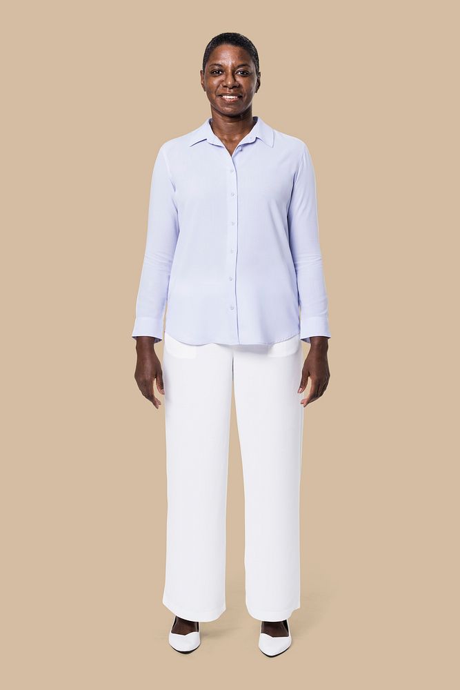 African American woman wearing blue long-sleeve shirt with white pants