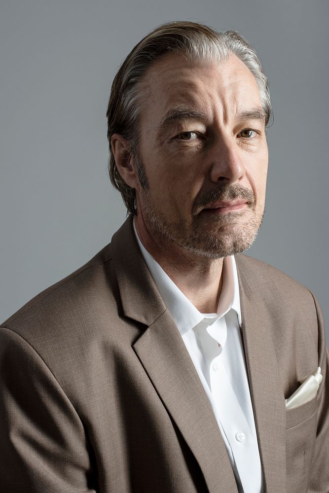 Bussinessman in brown suit studio portrait