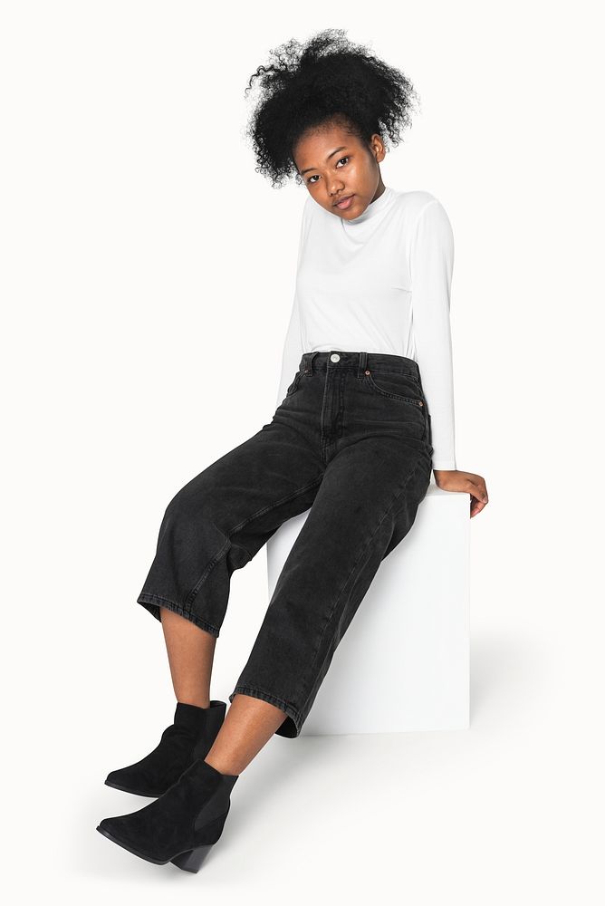 African American girl in white turtleneck and black jeans for winter apparel shoot