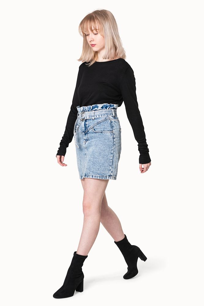 Blonde girl in black sweater and denim skirt for winter apparel shoot