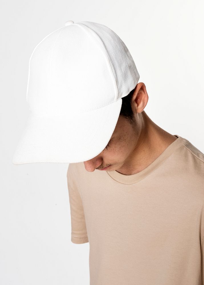 Teenage boy in white cap studio candid for street fashion shoot