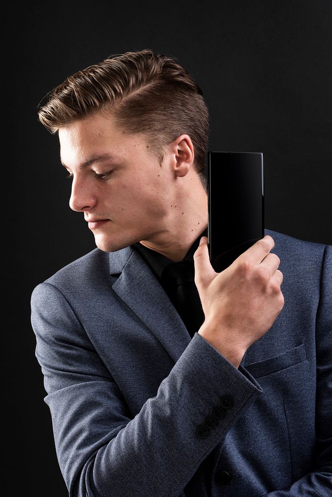 Businessman in suit show his smartphone device 