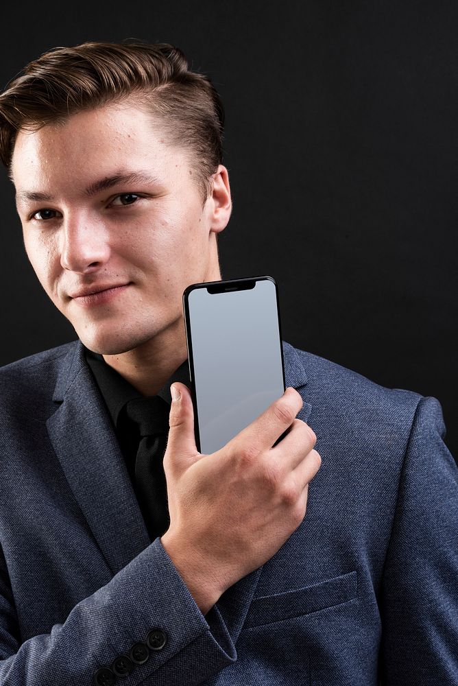 Businessman holding his smartphone device