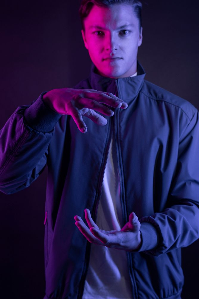 Man with hand gesture  purple light portrait