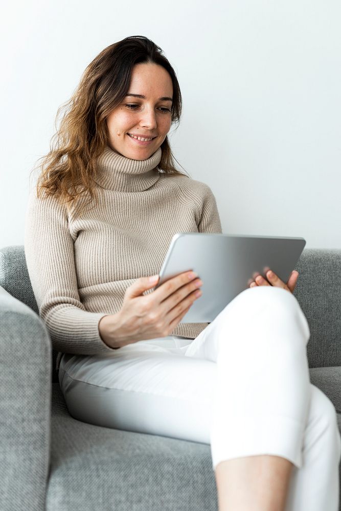 Woman using digital tablet on a couch