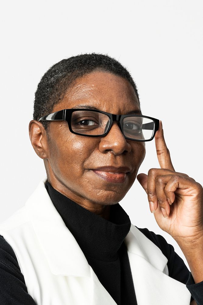 African American woman in beige suit portrait touching a glasses