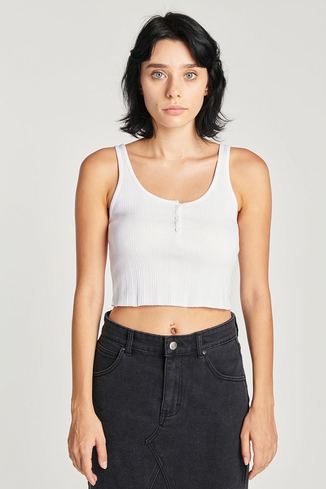 Woman in a white cropped tank top and a black skirt 