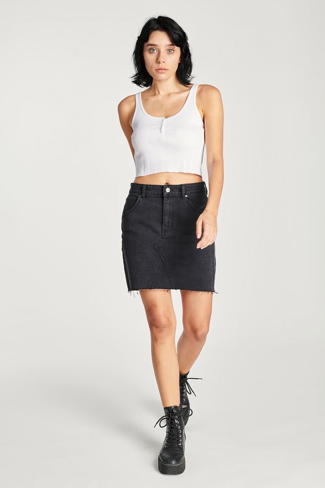 Cool woman in a black skirt and a white cropped top 