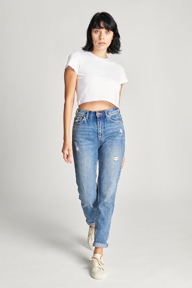 Woman in white crop top and high waisted jeans full body shot 