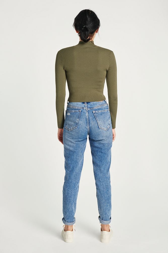 Back view woman wearing high neck top with blue jeans