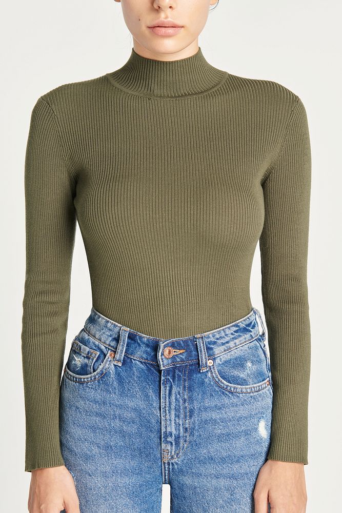 Green turtleneck top with high waisted blue jeans