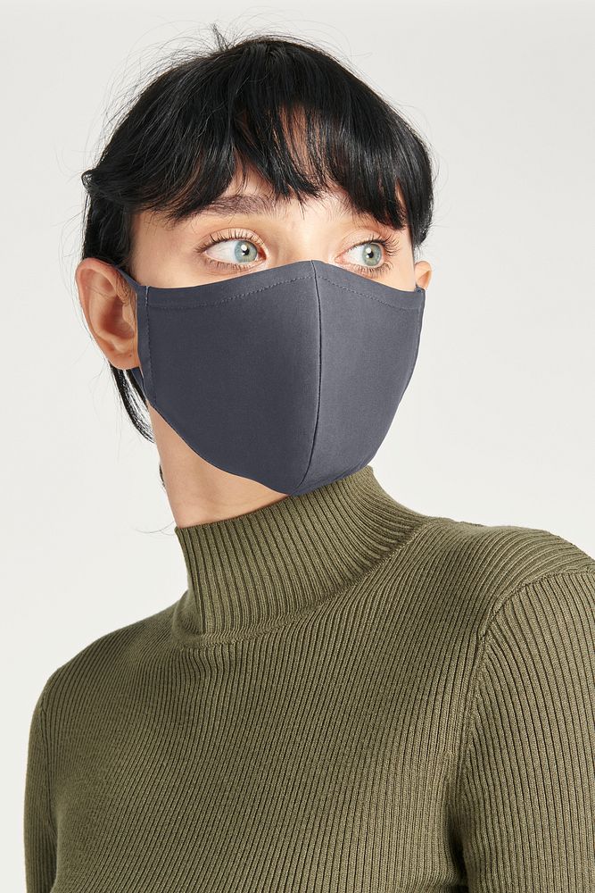 Face mask on a women in a green turtleneck top
