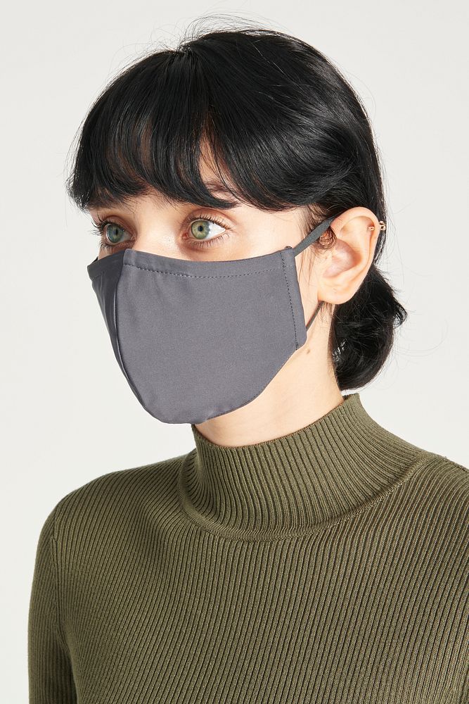 Face mask on a women in a green turtleneck top