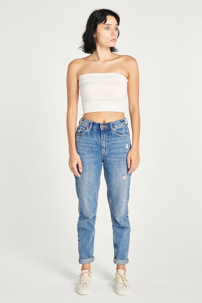 Woman in high-waisted jeans and a white bandeau top