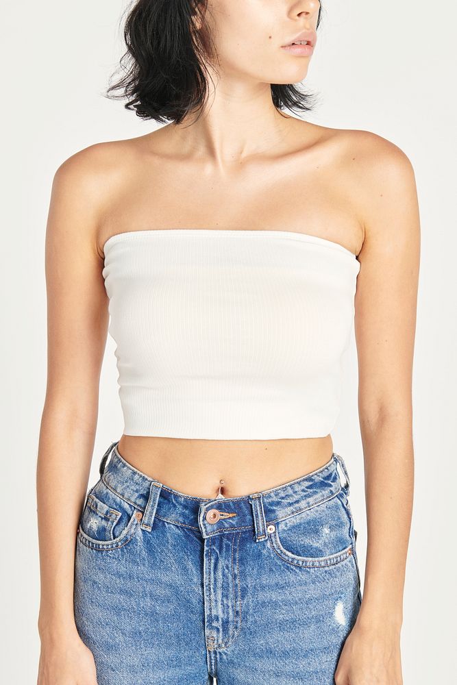Woman in high-waisted jeans and a white bandeau top