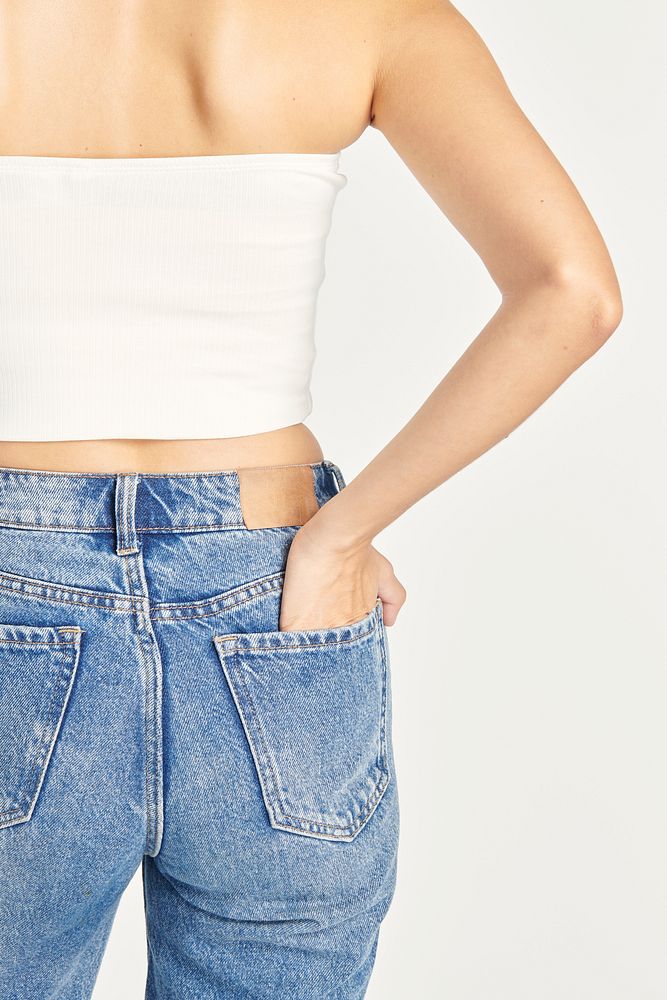 Woman in blue jeans and a white bandeau top