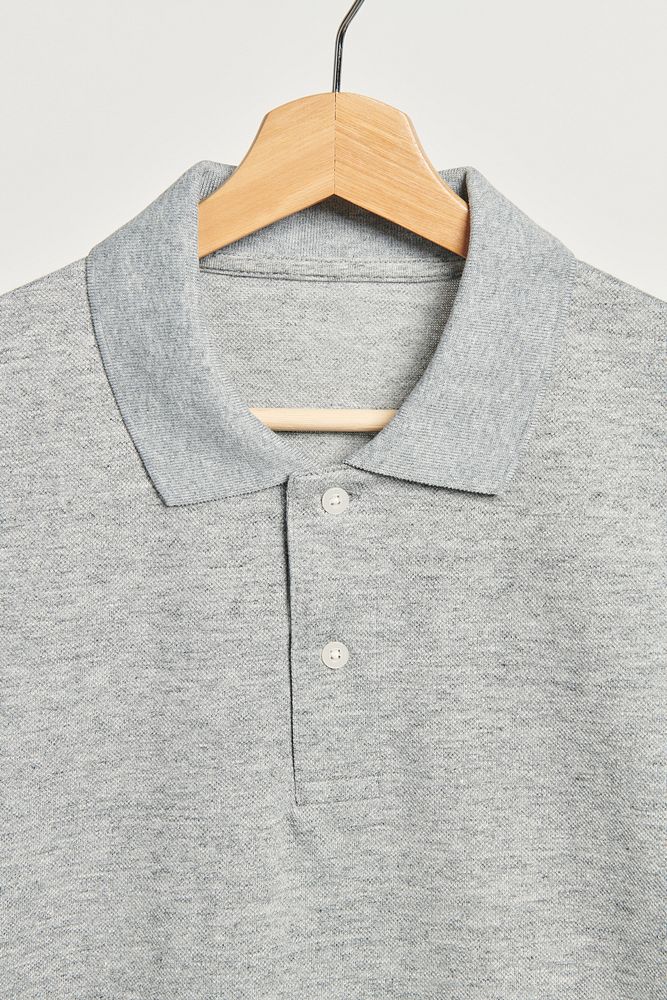 Gray collared men's shirt on a wooden hanger 