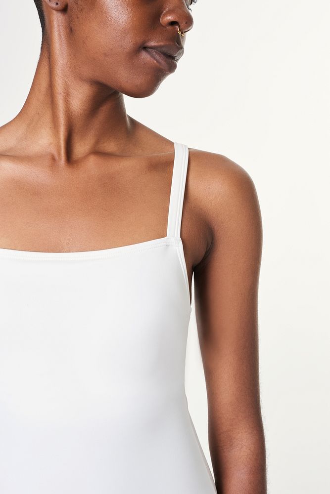 Black woman wearing a white sleeveless top 