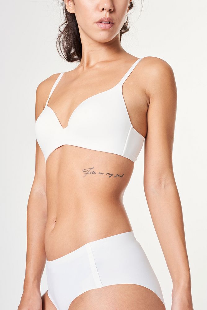 Tattooed woman in a white wireless bra and an underwears
