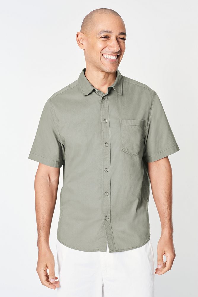 Happy man wearing a sage green shirt 