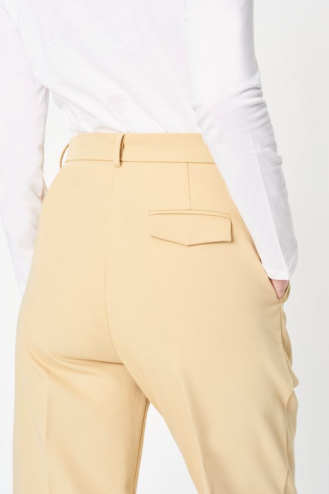 Woman wearing a white shirt and beige pants mockup 