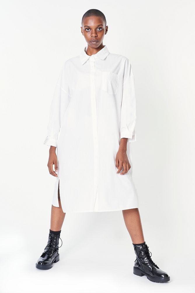 Black woman wearing ankle boots with a white shirt dress