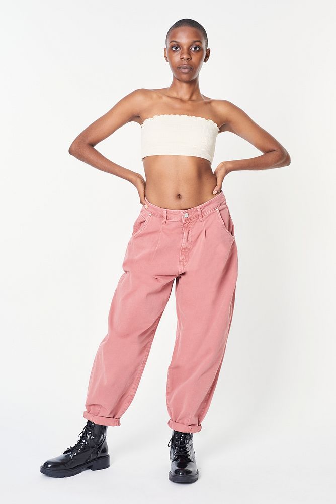 Black woman in pink jeans and a white bandeau top