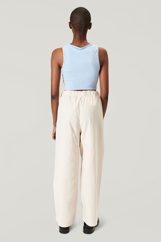 Women's blue crop top with beige pants psd mockup
