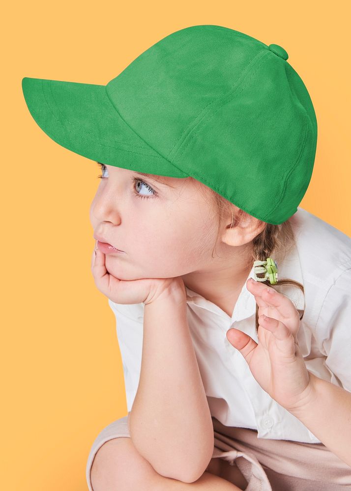 Girl wearing green cap in studio