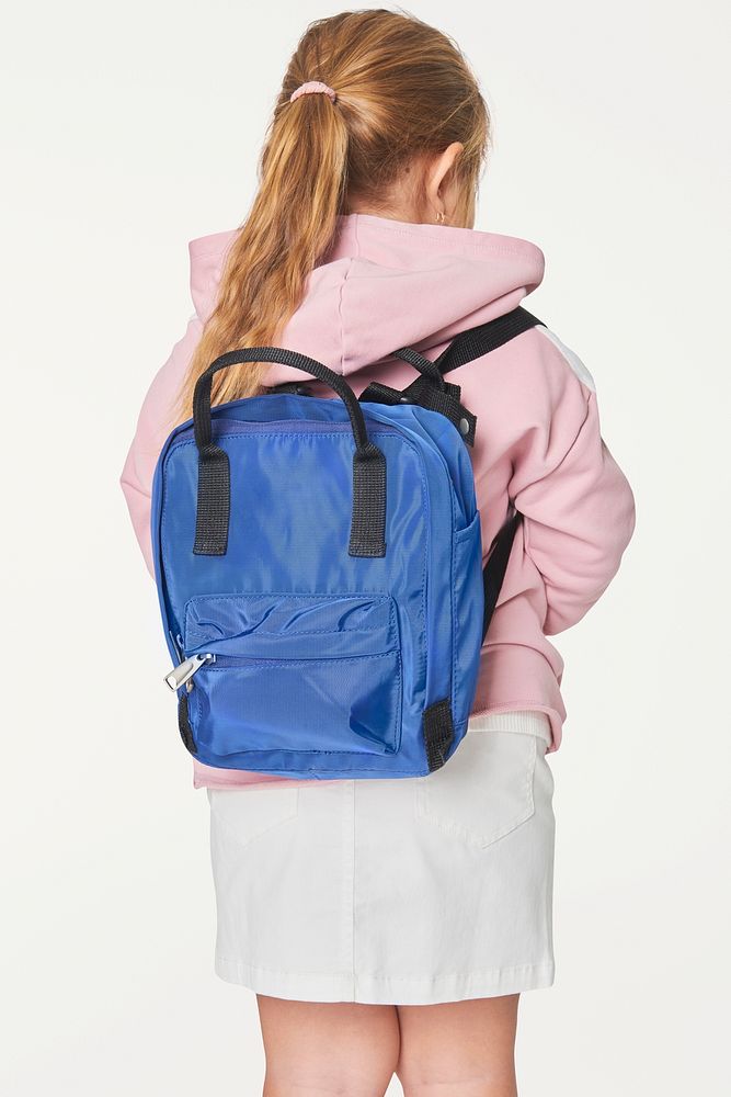 Girl with blue school bag in studio