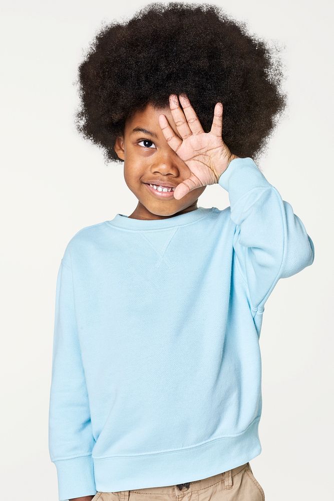 Black boy wearing blue sweater in studio