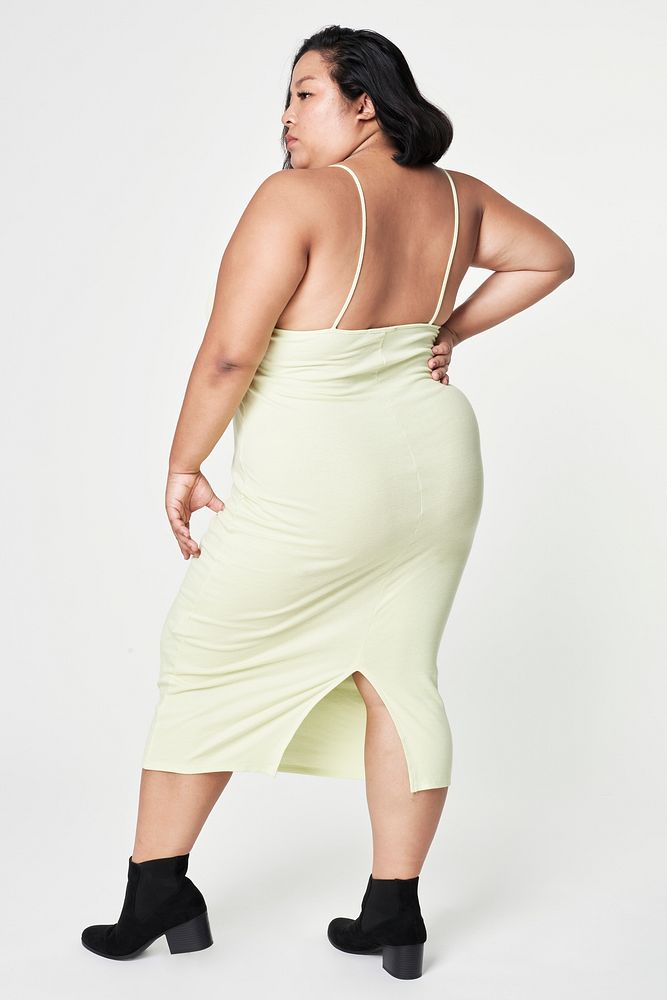 Woman facing backward size inclusive fashion green dress mockup
