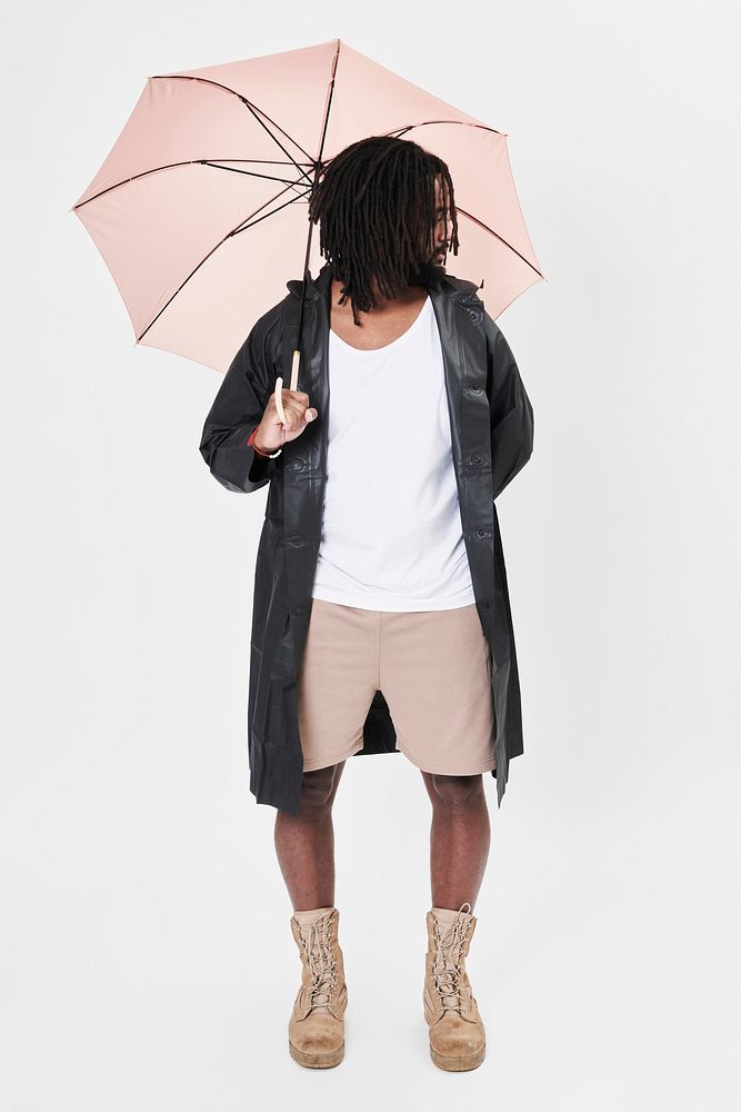 Man holding pink umbrella studio shot