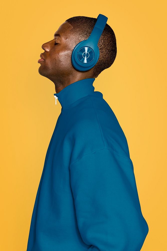 Man wearing blue headphones and outfit 