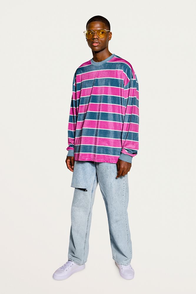 Stylish man posing in pink striped sweater 