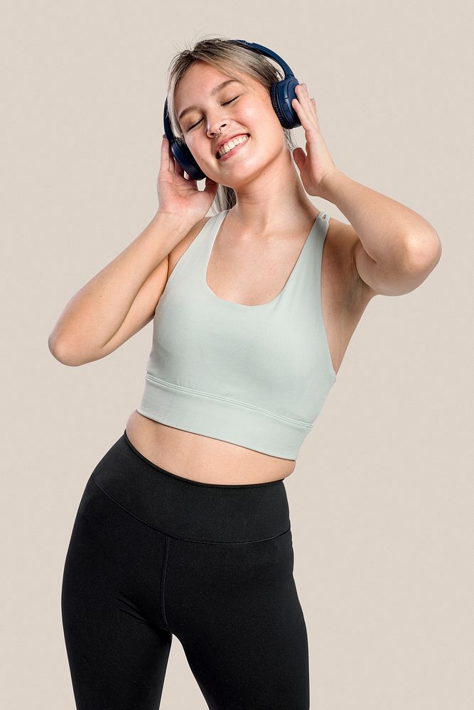 Sporty woman listening to music from headphones