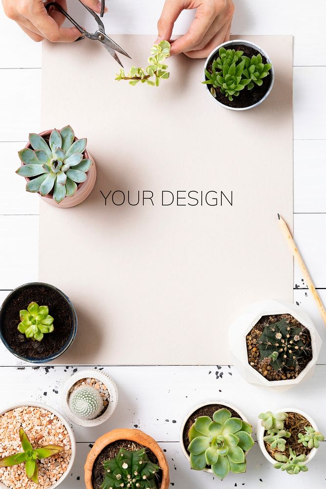 Poster mockup psd on wooden table with plants flat lay