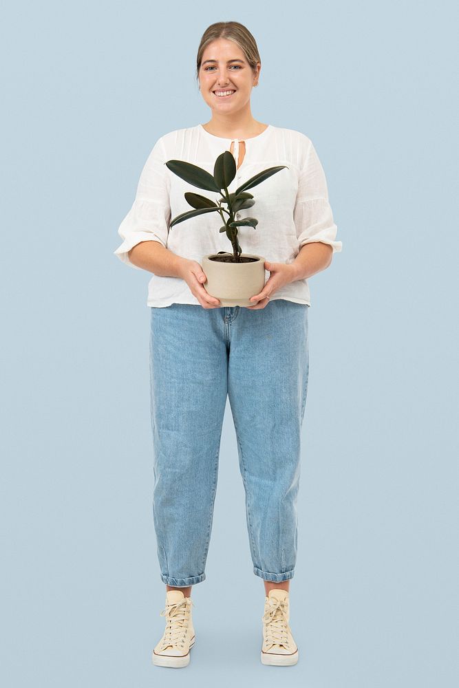 Happy plant parent holding potted rubber plant