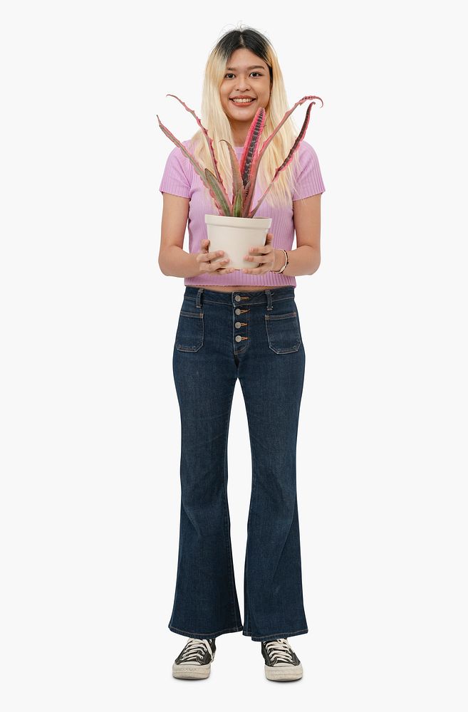 Asian woman holding potted houseplant
