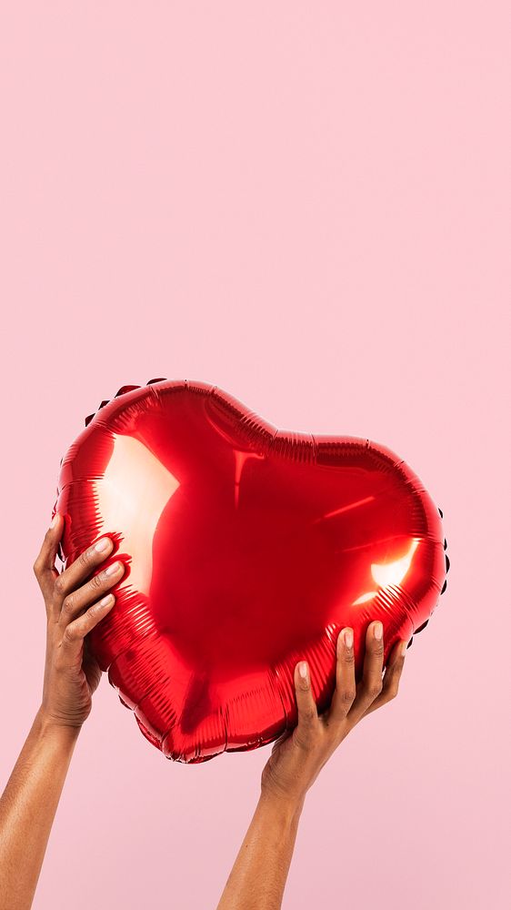 Valentines heart balloon held by a person