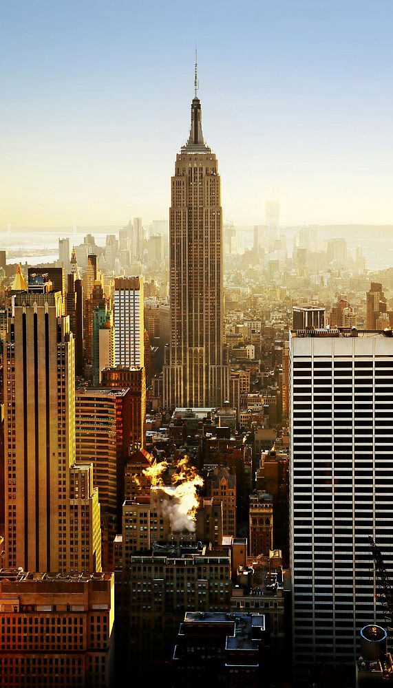 View of the Empire State Building between skyscrapers in the New York City skyline. Original public domain image from…