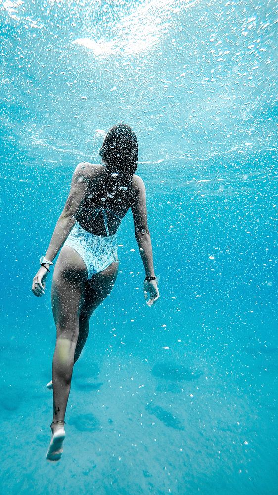 Summer mobile wallpaper, woman swimming in ocean background. Original image from Wikimedia Commons